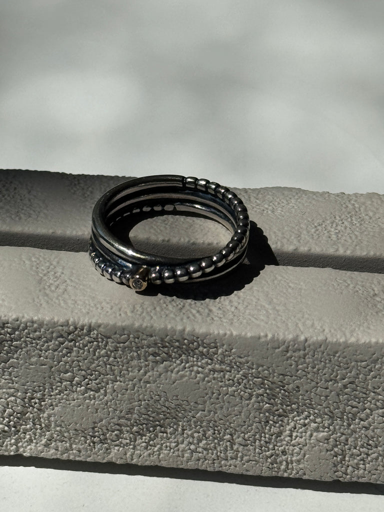 Sterling silver band with 14kt gold + tiny diamond size 6.5