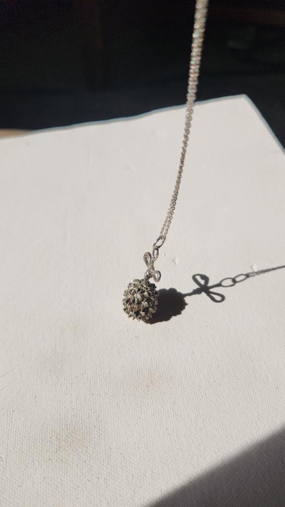 Vintage artisan sterling dandelion bow pendant